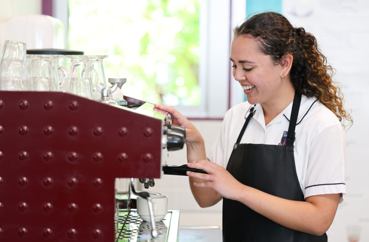 Student making coffee with a coffee machine