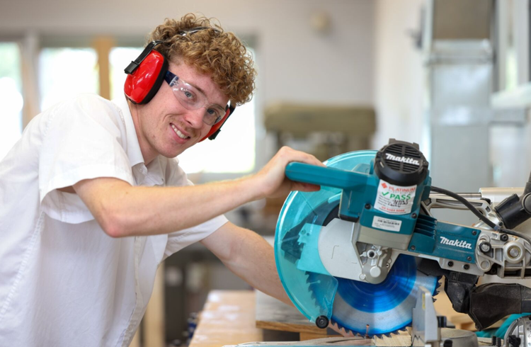 student with circular saw