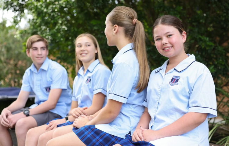 4 students sitting outside