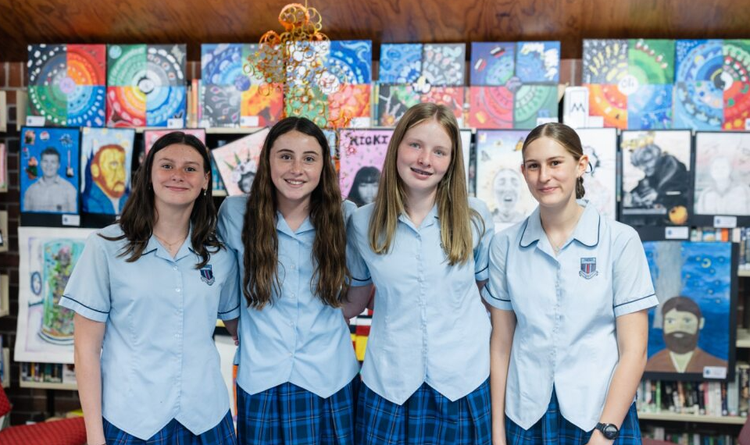 4 students in front of art